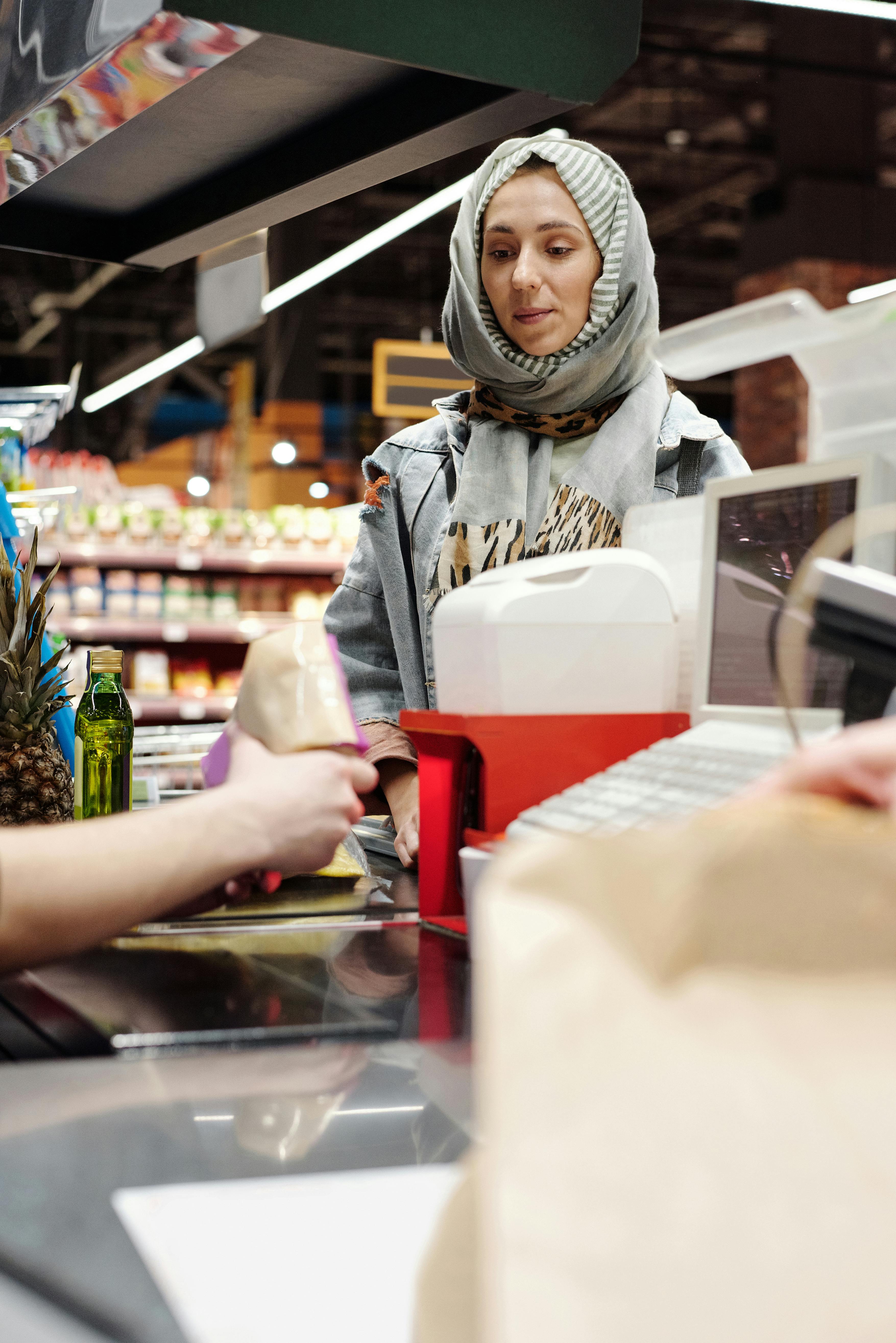 woman in a hijab buying groceries