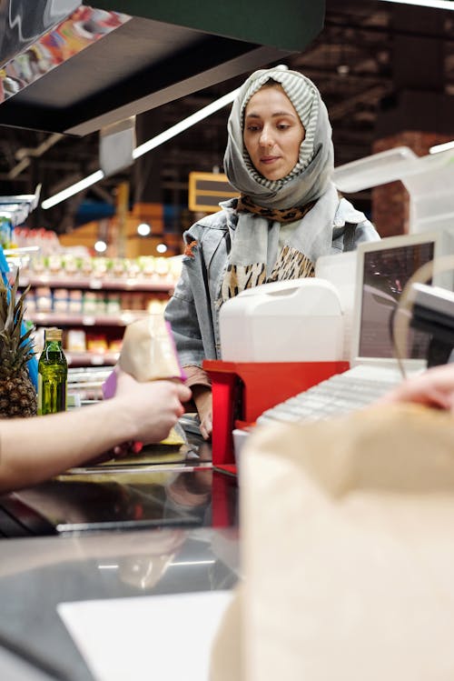 Free Woman in a Hijab Buying Groceries Stock Photo