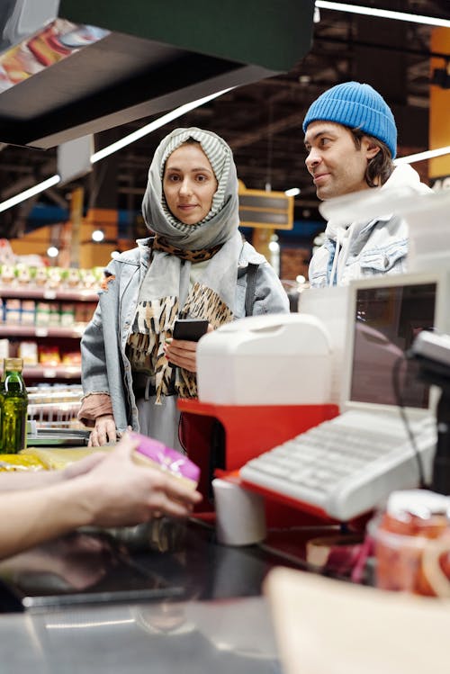 Free Couple Buying Groceries at a Supermarket Stock Photo