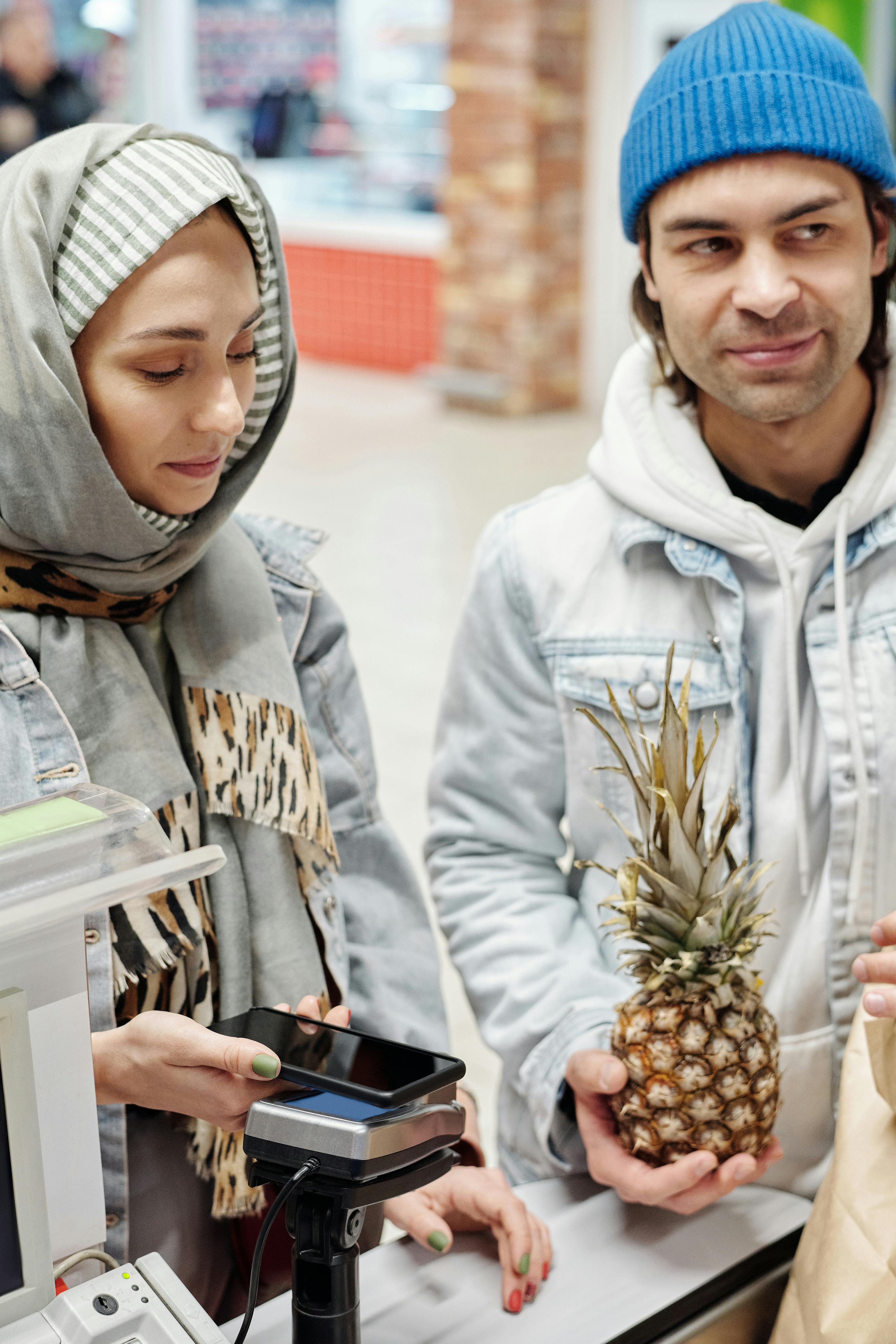 couple buying a pineapple