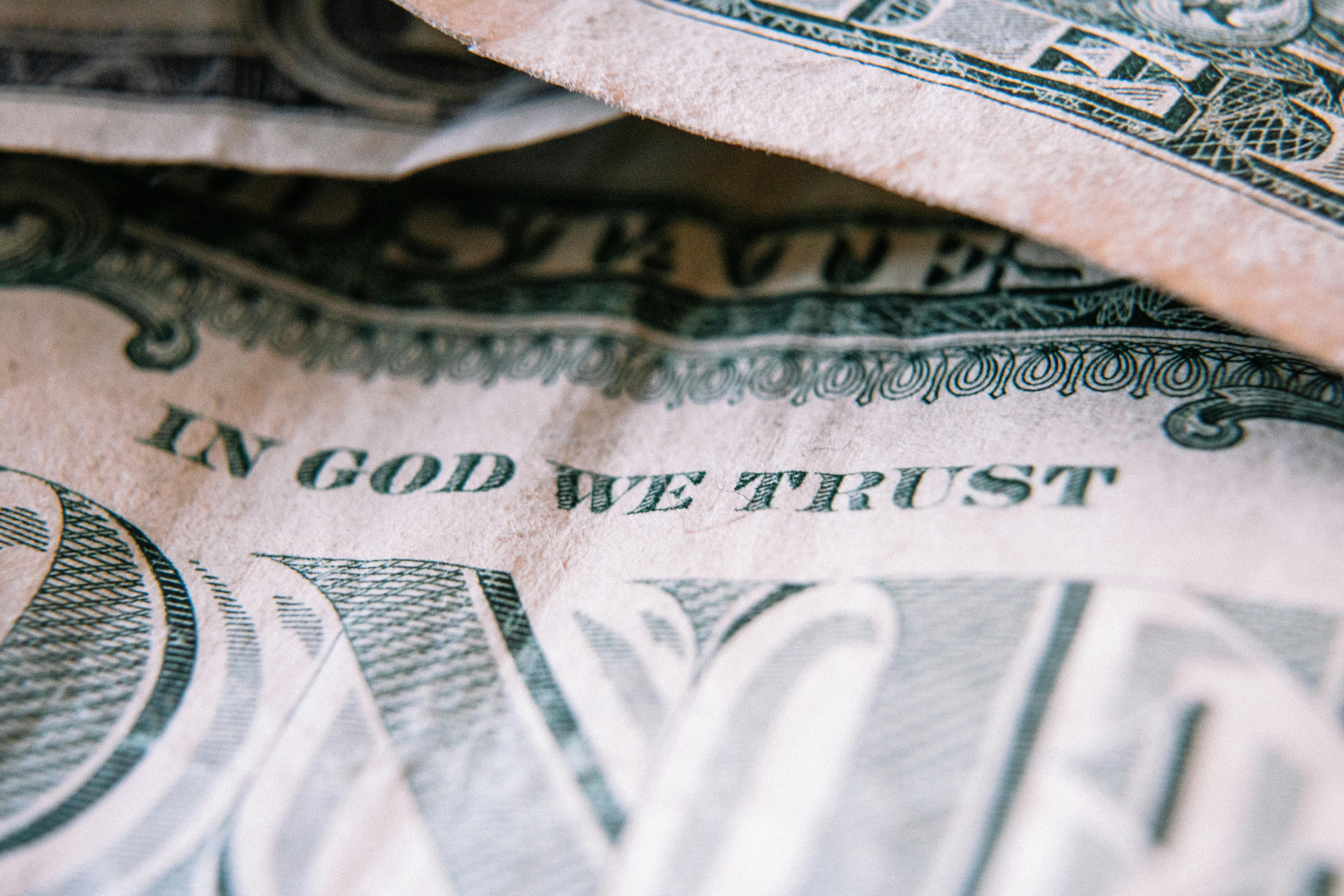 one dollar banknotes placed on table