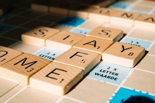 Free From above of wooden letter tile of board game arranged in words on table Stock Photo