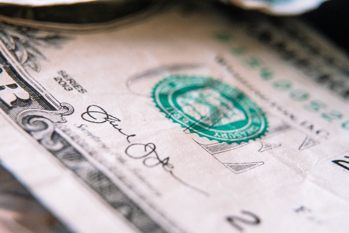 One US dollar banknote on table