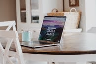 MacBook on Brown Wooden Table