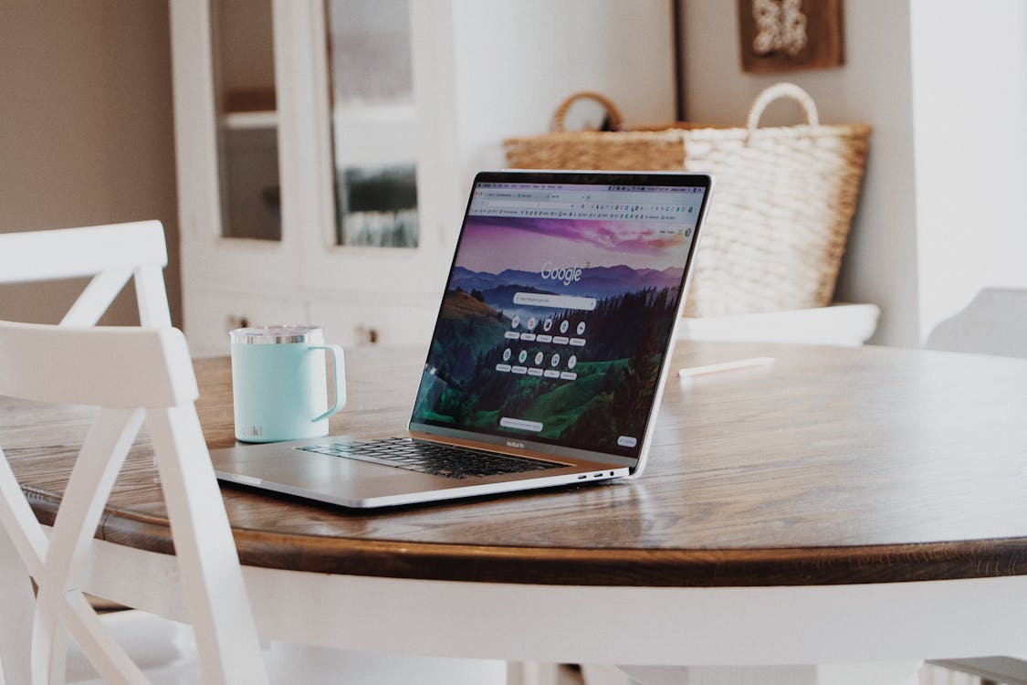 Free MacBook on Brown Wooden Table Stock Photo