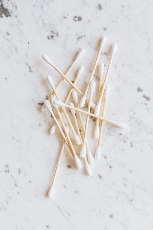 Photo of White Cotton Buds on White Surface