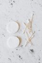 Set of cotton buds and pads on marble surface