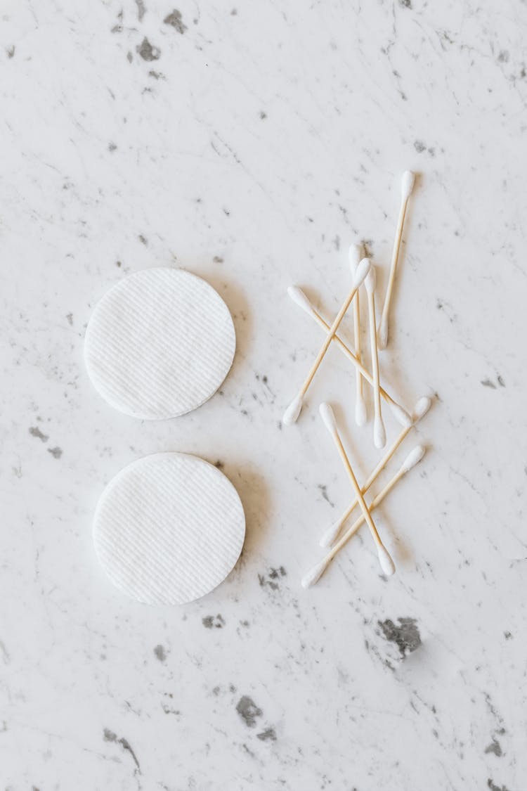 Set Of Cotton Buds And Pads On Marble Surface