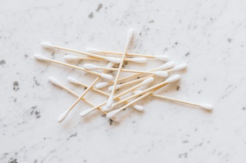 Free Cotton Buds on White Surface Stock Photo