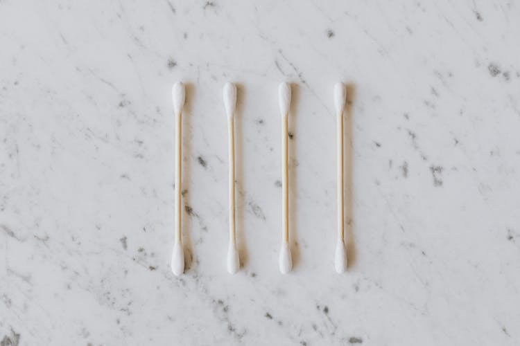 Similar Cotton Ear Buds On Wooden Sticks On Table