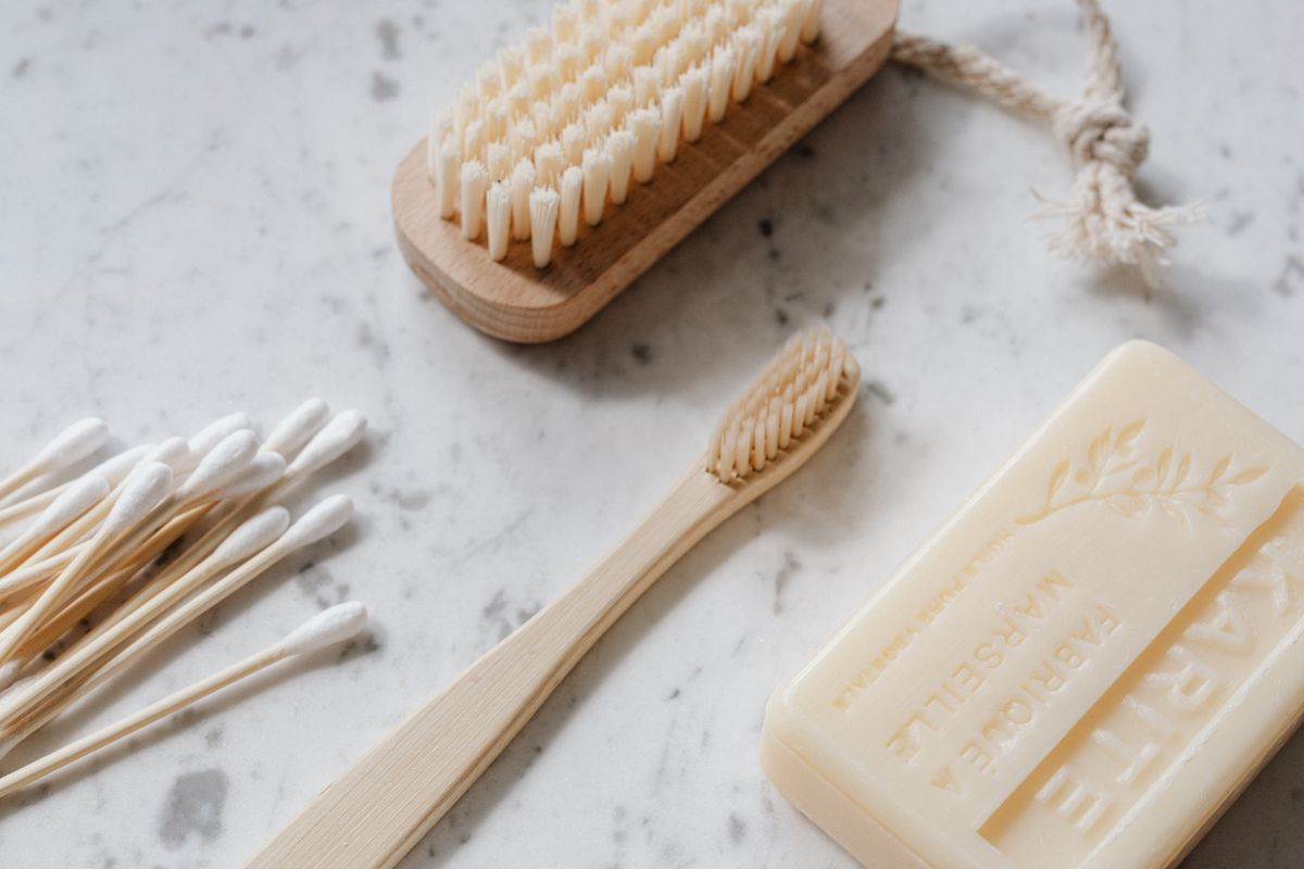 Soap, a toothbrush, and personal-care items arranged on a light surface