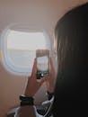 Woman Taking Photo in Airplane