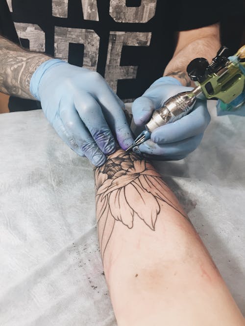 Person Using Tattoo Machine