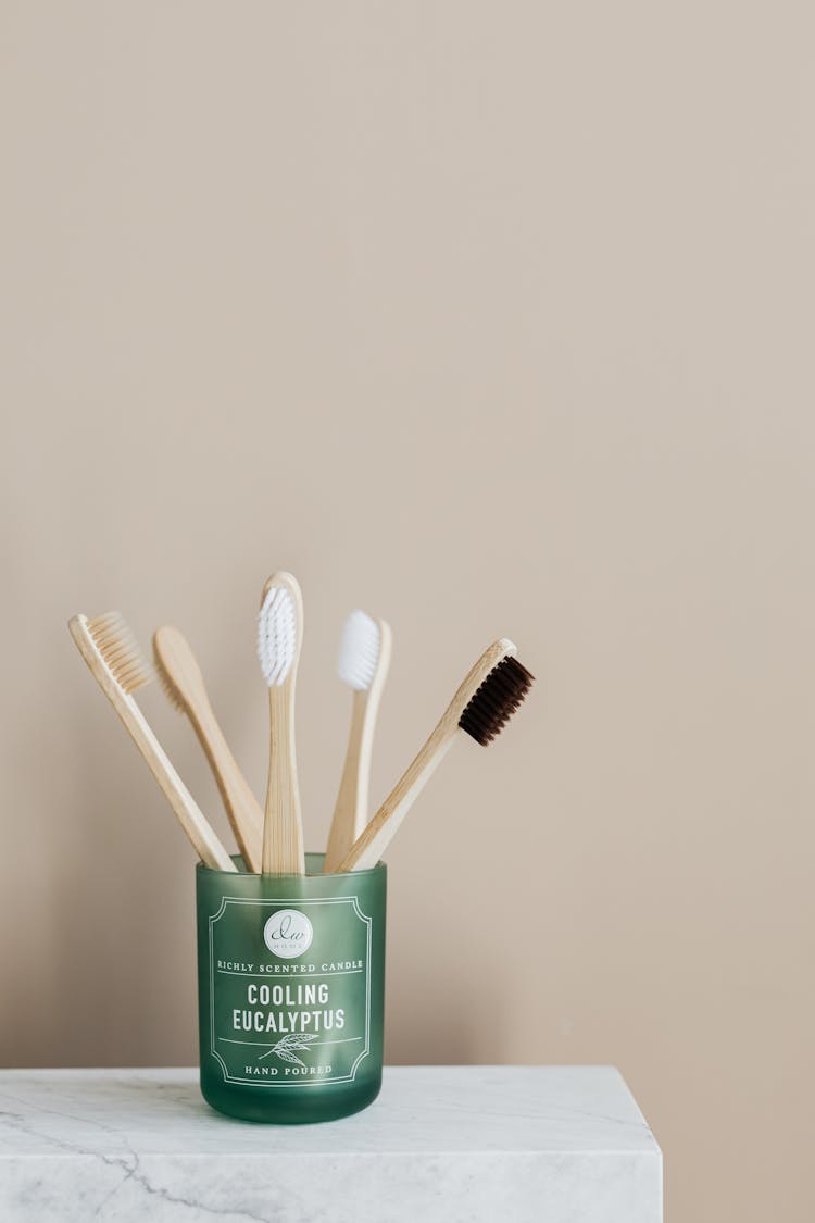 Bamboo Toothbrushes In Green Holder On Marble Table