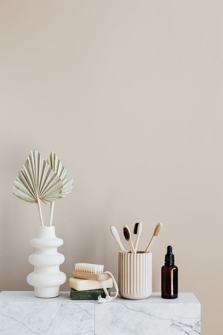 Set Of Natural Toiletries On Marble Table In Bathroom