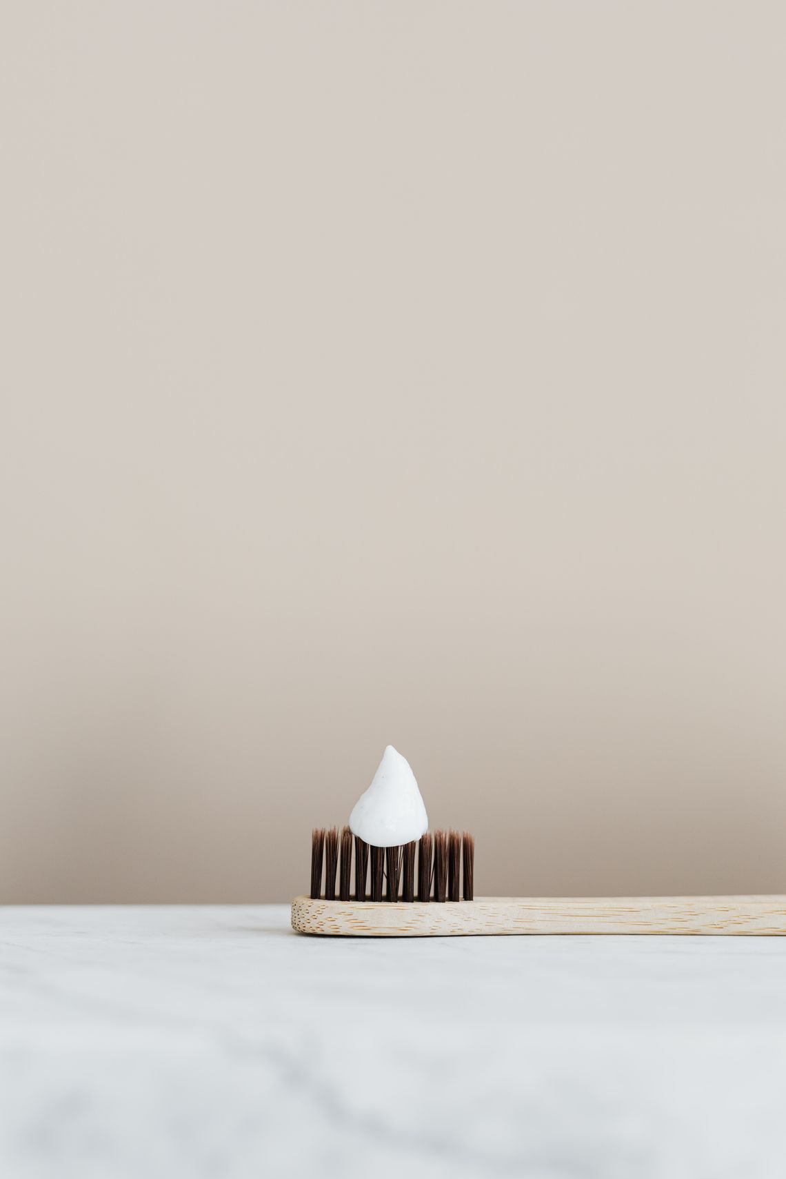 Minimal bamboo toothbrush with toothpaste for a daily oral care routine