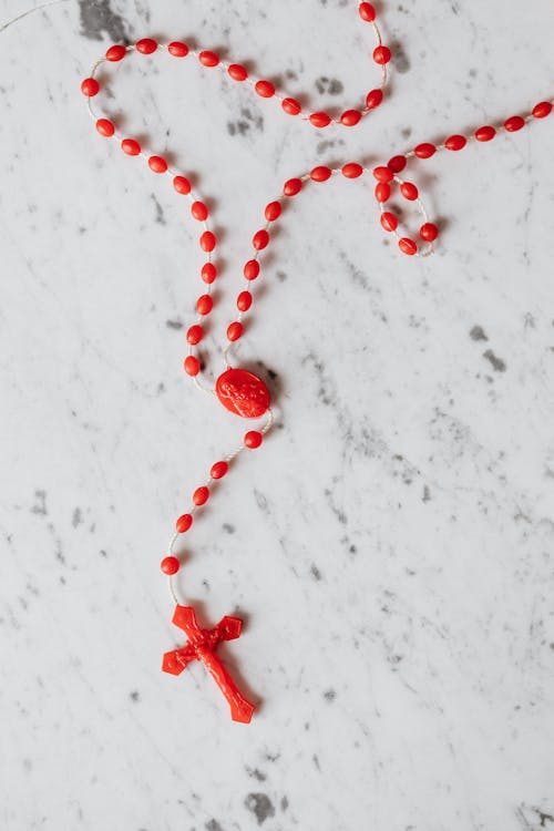 Free Red Rosary on White Surface Stock Photo