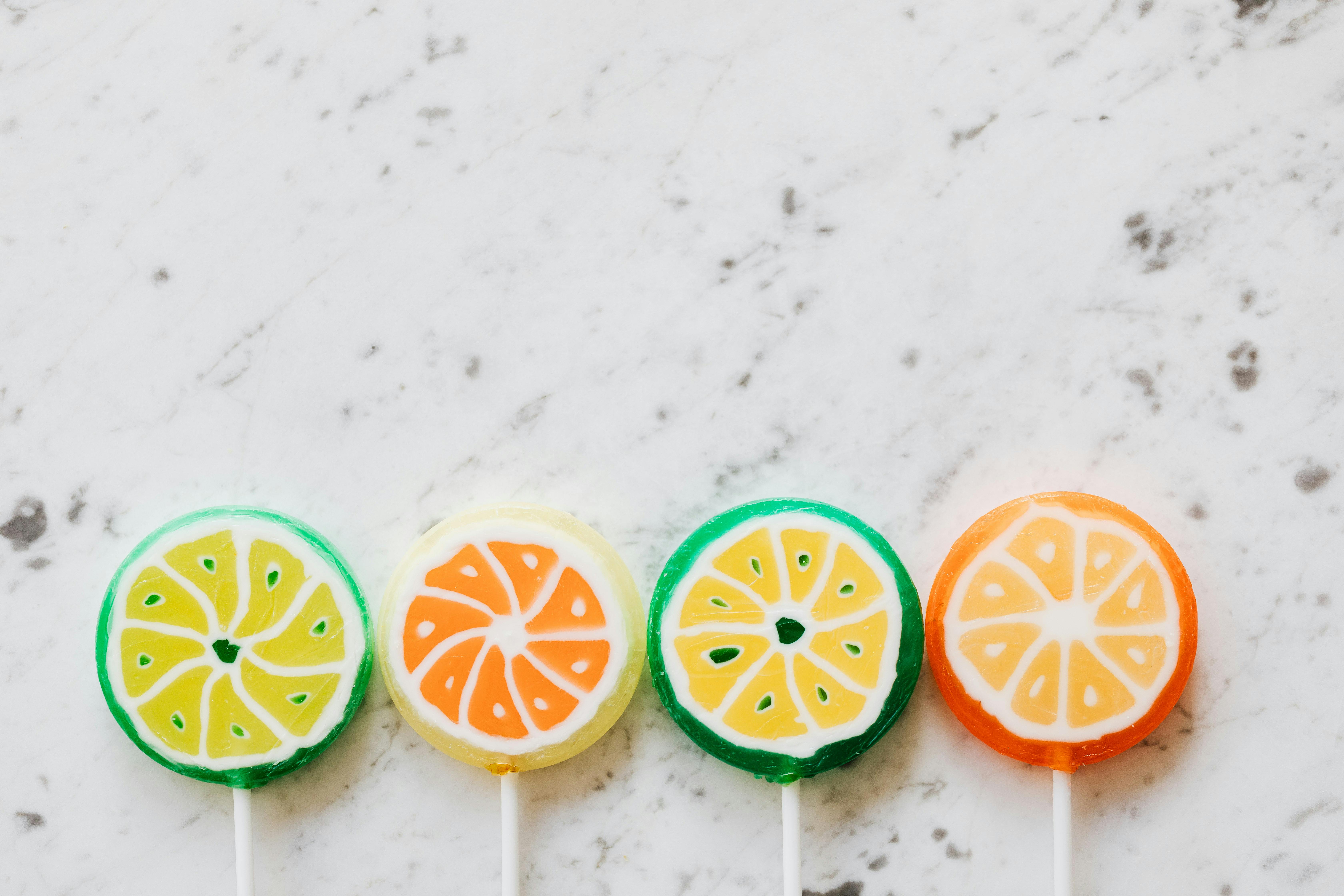 various multicolored fruit like lollipops on table