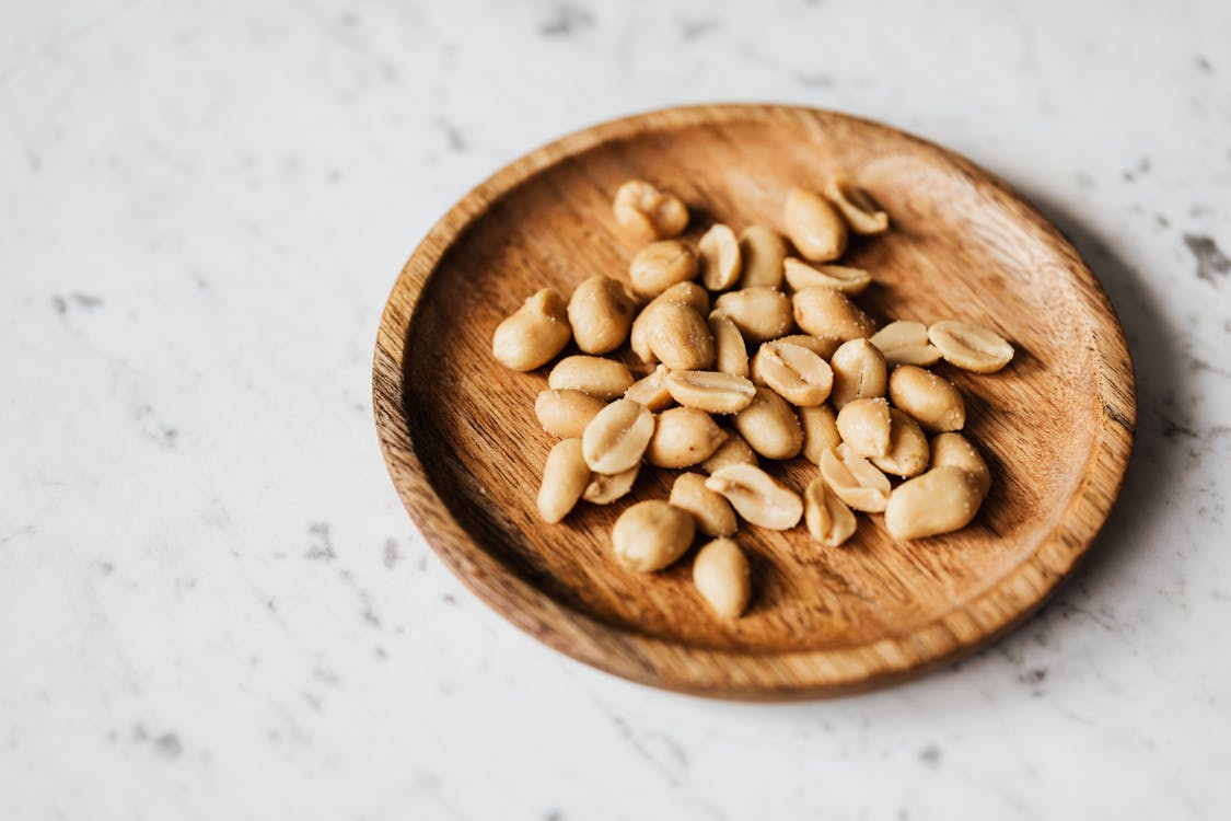 Free Brown Wooden Round Bowl With Brown Nuts Stock Photo