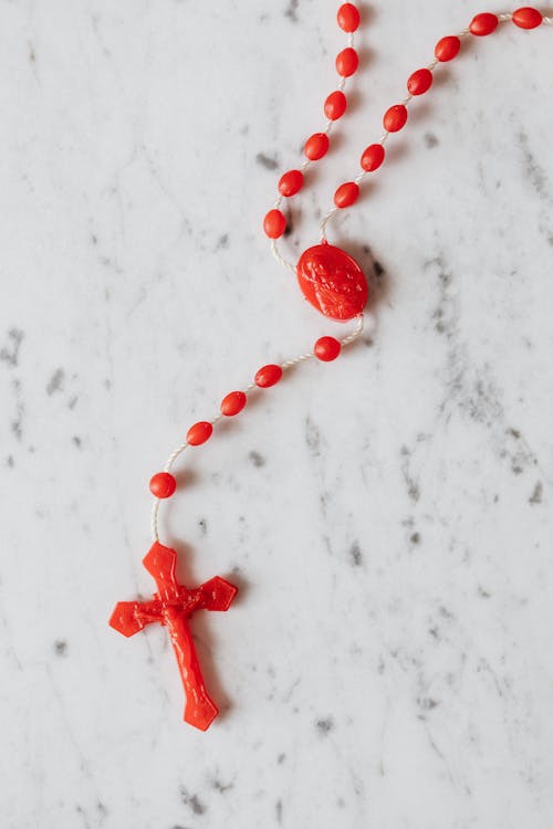 Free Photo of Red Rosary on White Surface Stock Photo