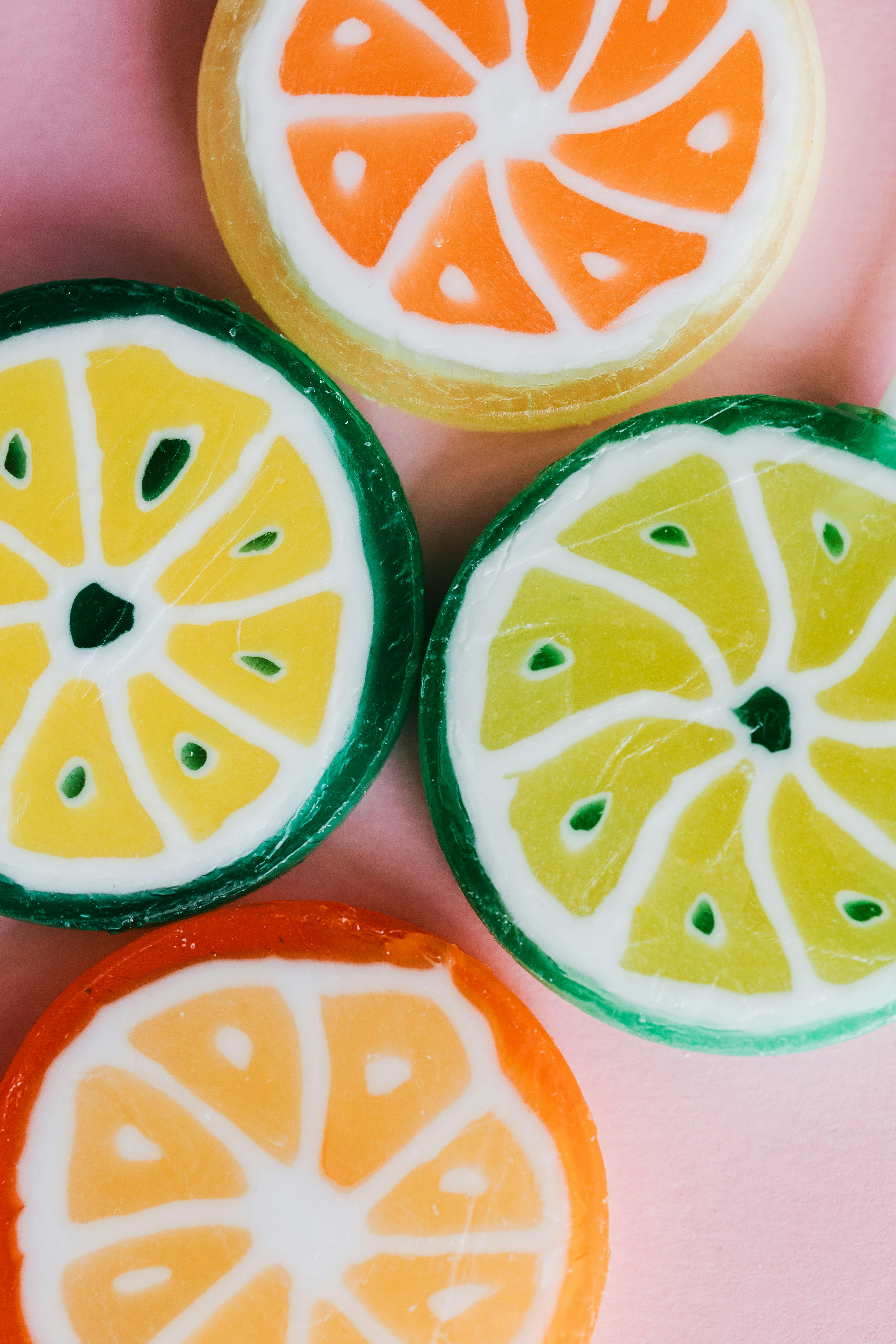 different multicolored candies on pink background