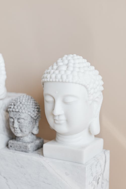 Tibetan marble busts of Buddha on beige background