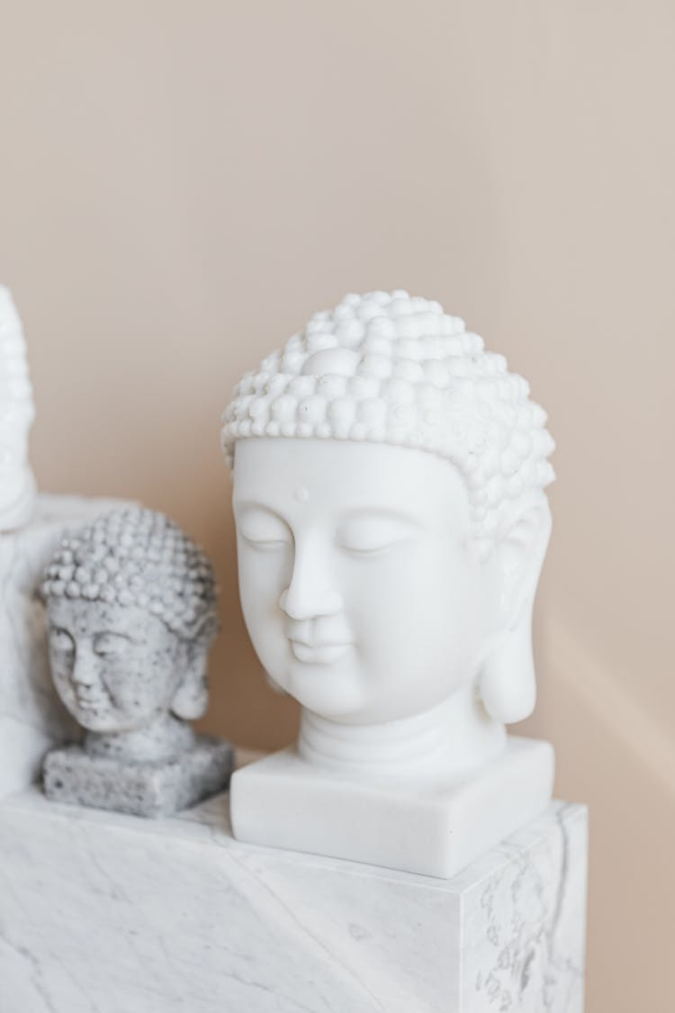 Tibetan Marble Busts Of Buddha On Beige Background