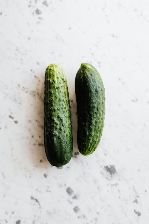 Green Cucumber on White Surface
