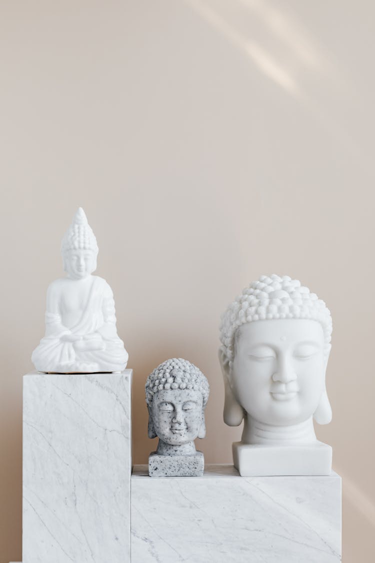 Composition Of Buddha Statues On Marble Stand