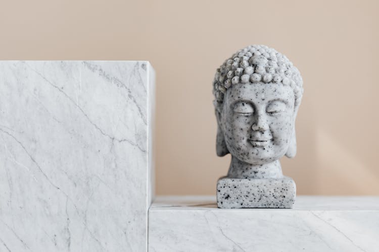 Traditional Stone Buddha Statue On Marble Shelf