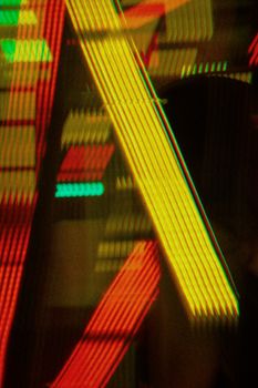 Abstract neon lights form vivid patterns in a Singapore night scene, emphasizing urban vibrancy.
