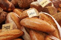 Assorted artisan bread loaves at a bakery, showcasing fresh and rustic textures.