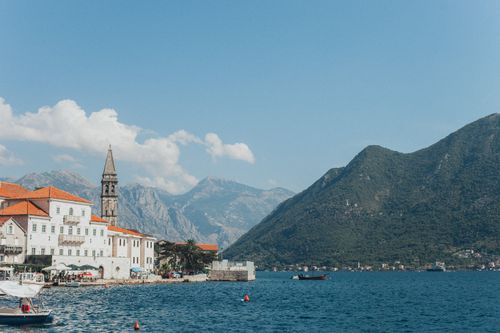 Free Charming waterfront town with clear mountain views and serene sea. Stock Photo