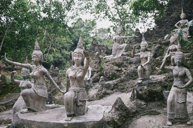 Stone statues of dancers in the jungle at Tarnim Magic Garden, Koh Samui