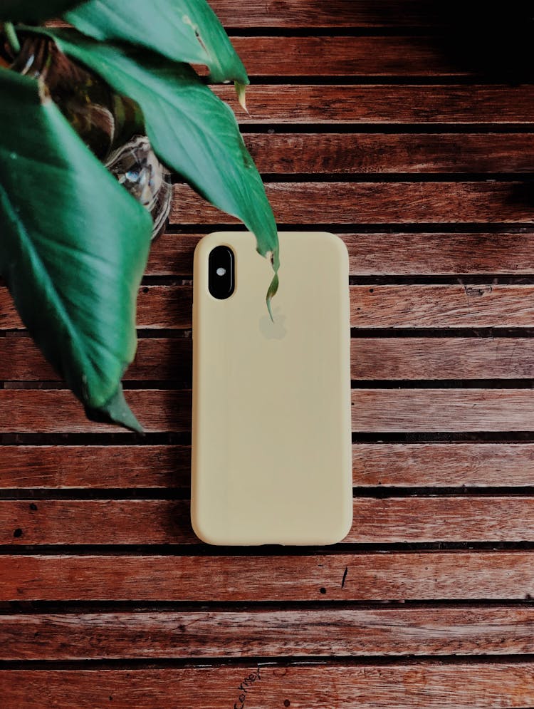 Beige Iphone Case On Brown Wooden Surface