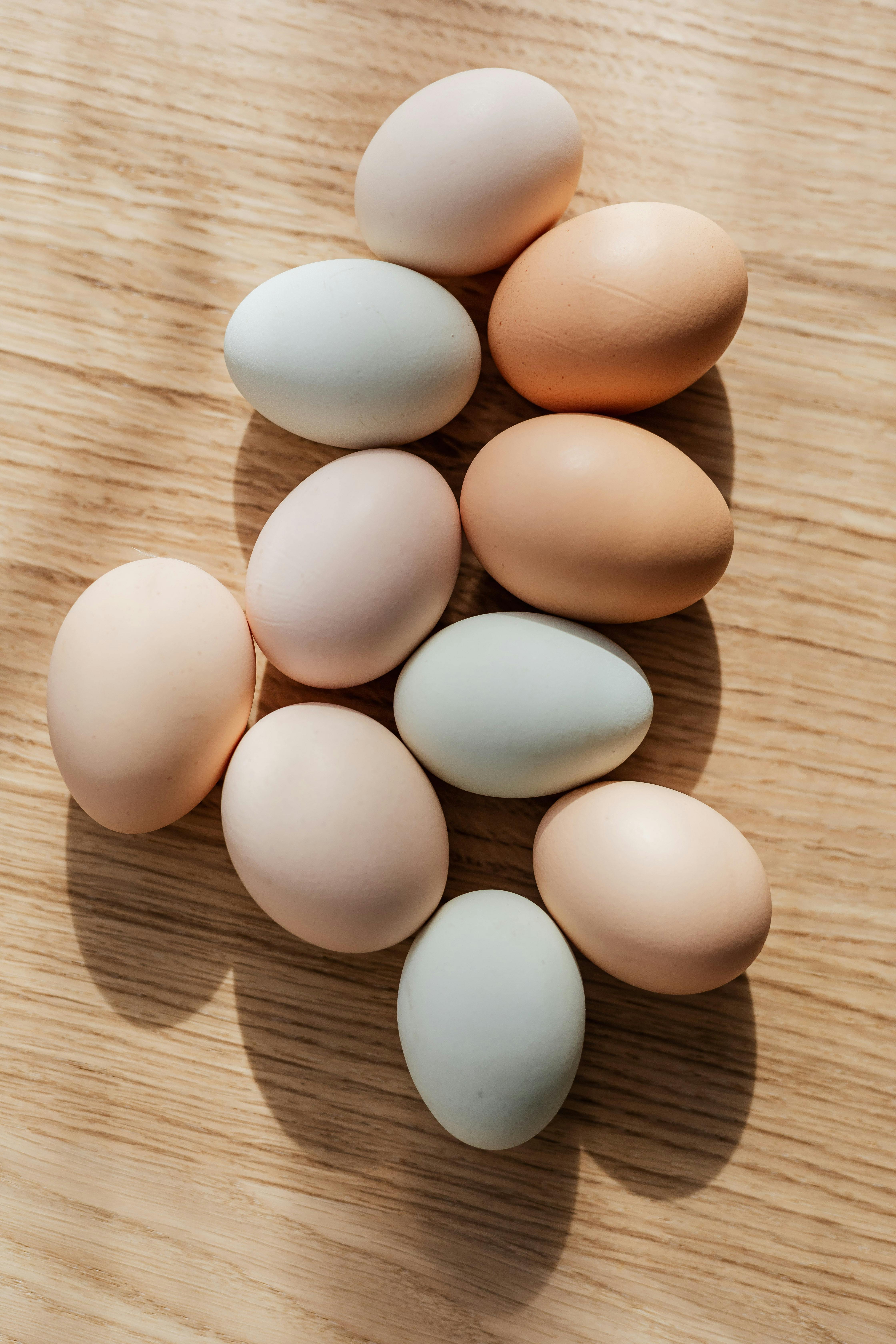 Set of multicolored raw eggs on wooden table · Free Stock ...