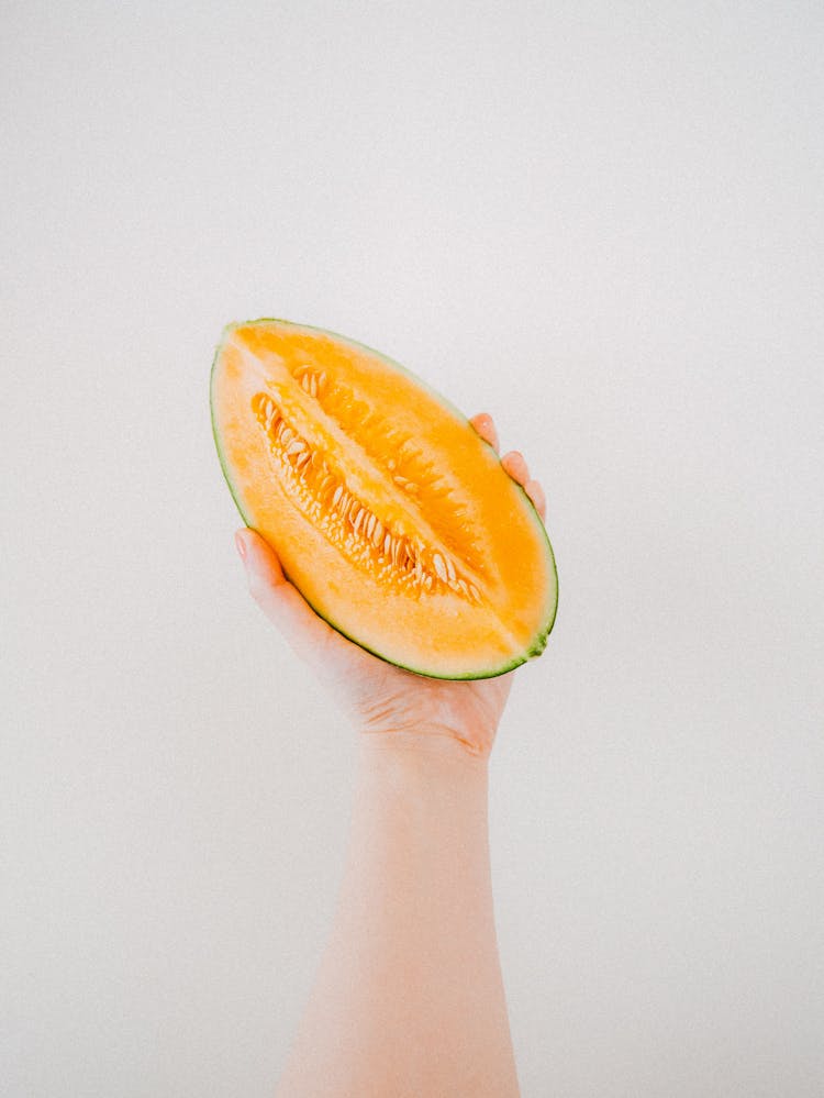 Person Holding A Sliced Watermelon 