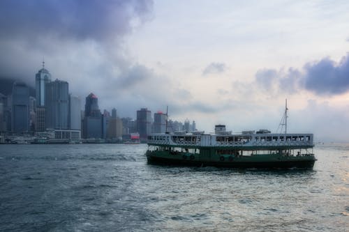Free Barge on Body of Water Near High-rise Buildings Stock Photo