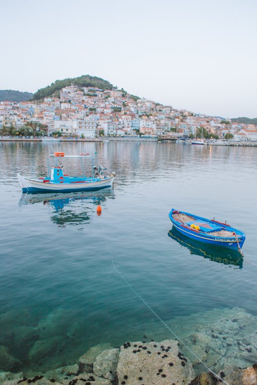 Fishing Boats Near a City