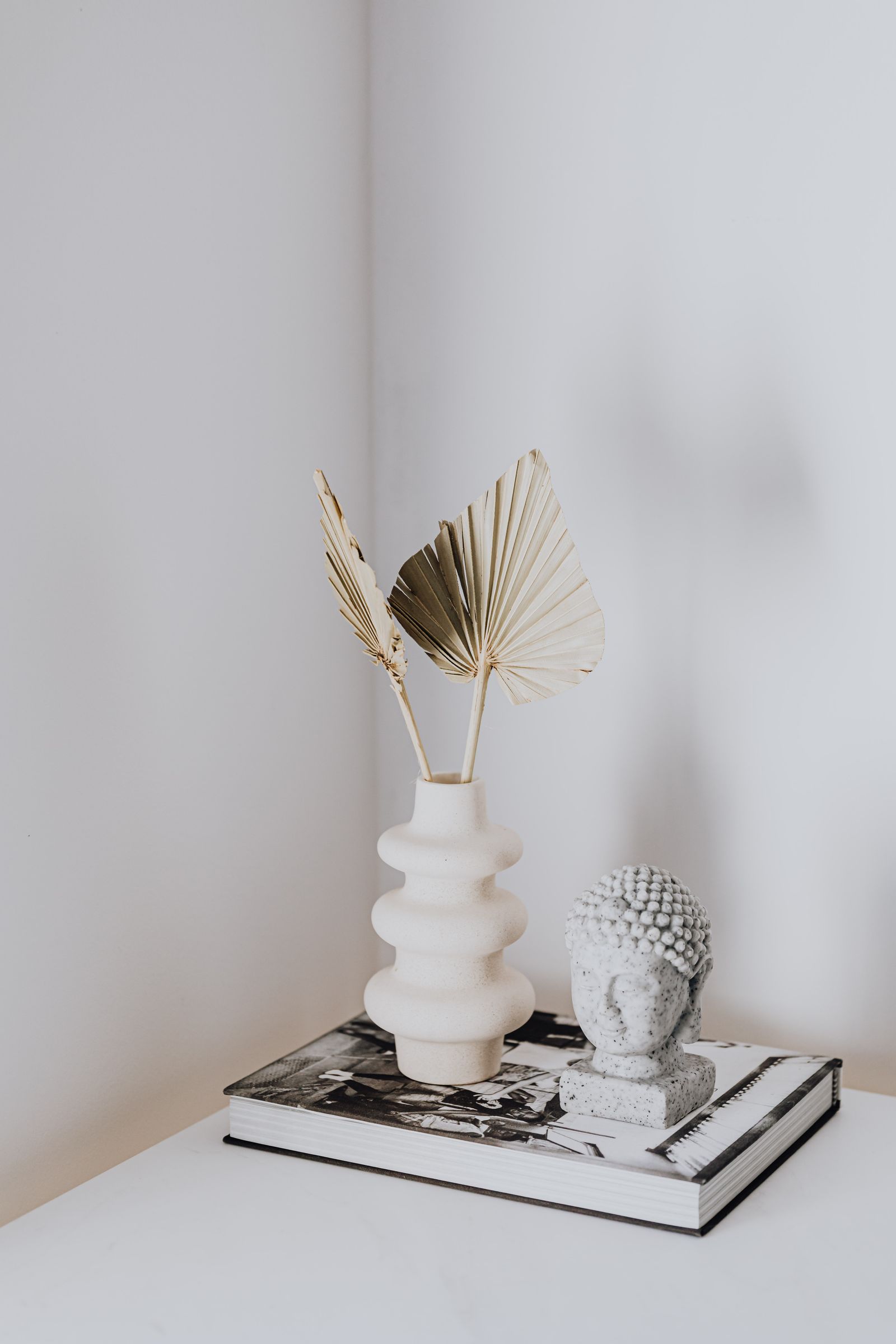 A quiet studio corner with dried flowers and neutral styling