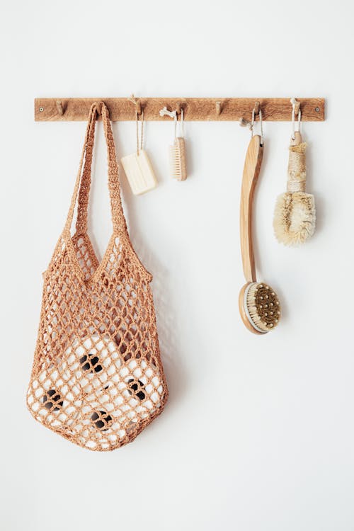 Body brushes and toiletries on wooden hanger