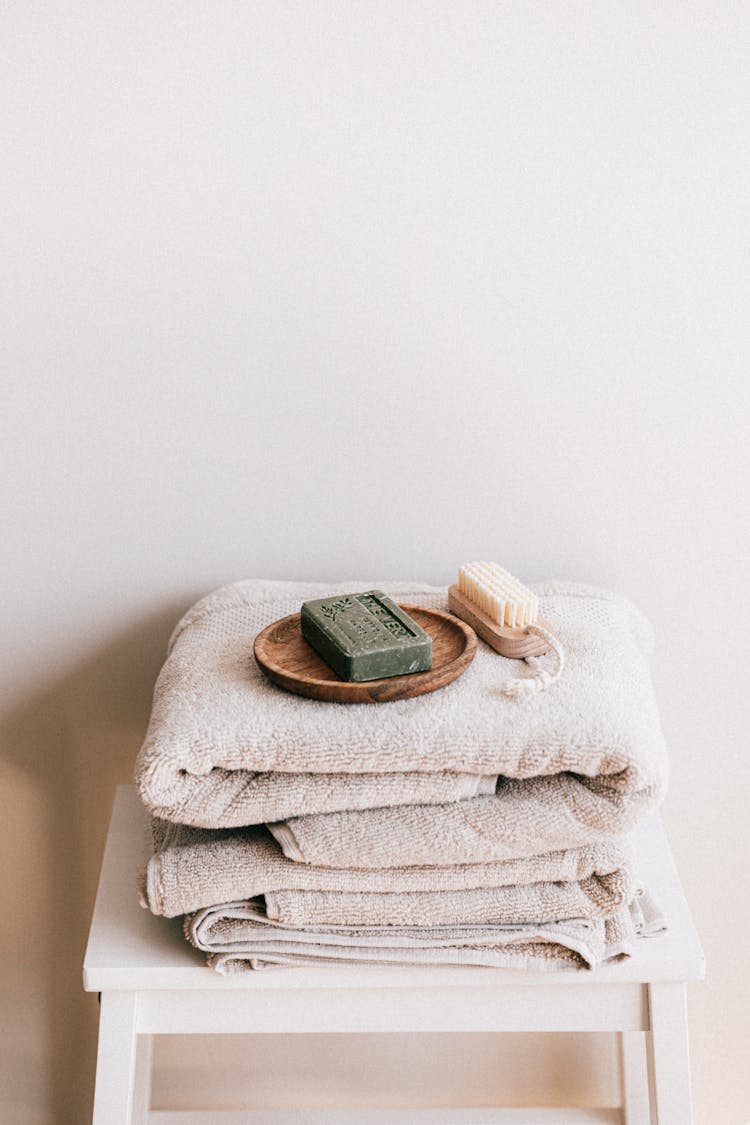 Natural Toiletries And Towels On Stool