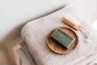 Natural soap and brush on folded towels