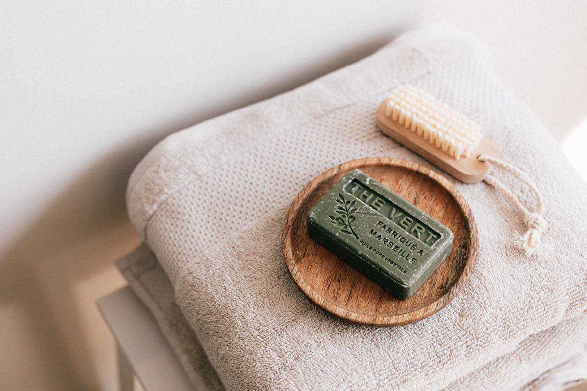 Natural soap and brush on folded towels