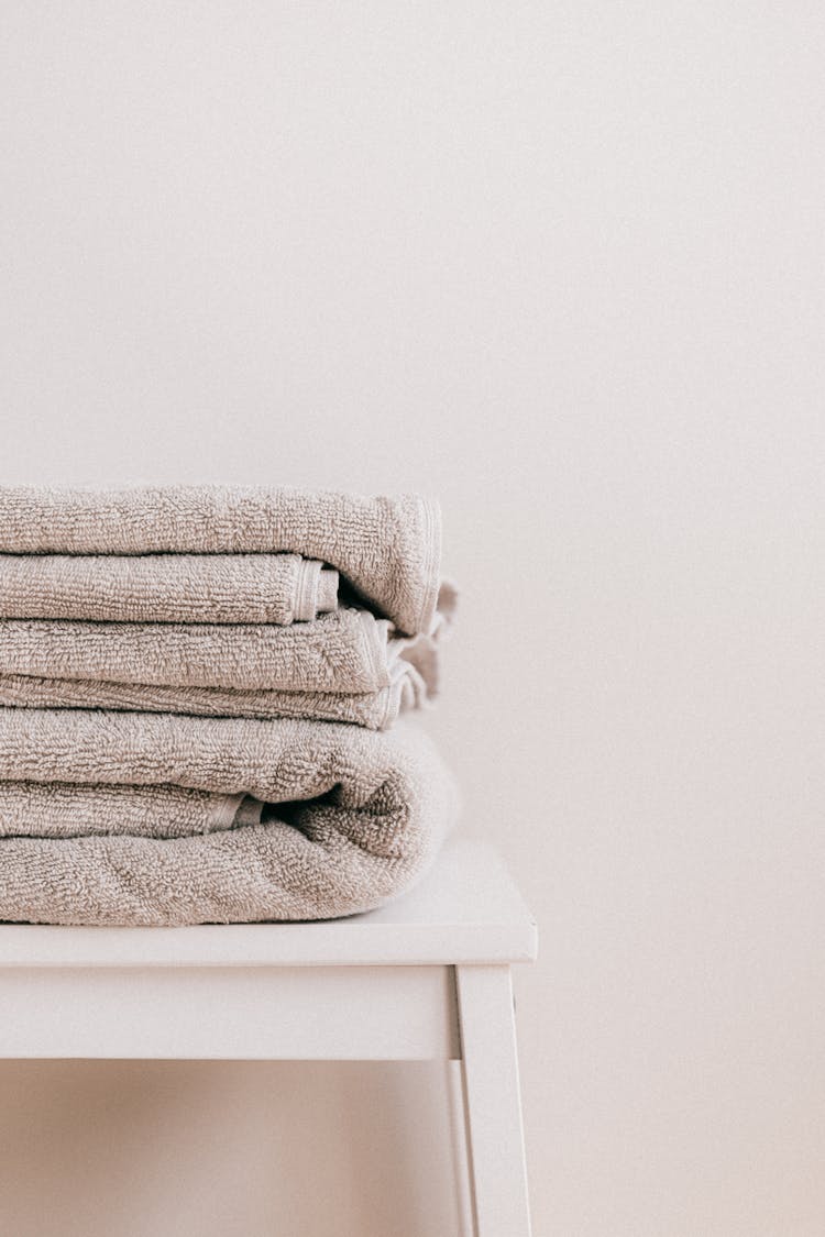 Stack Of Clean Towels On White Stool