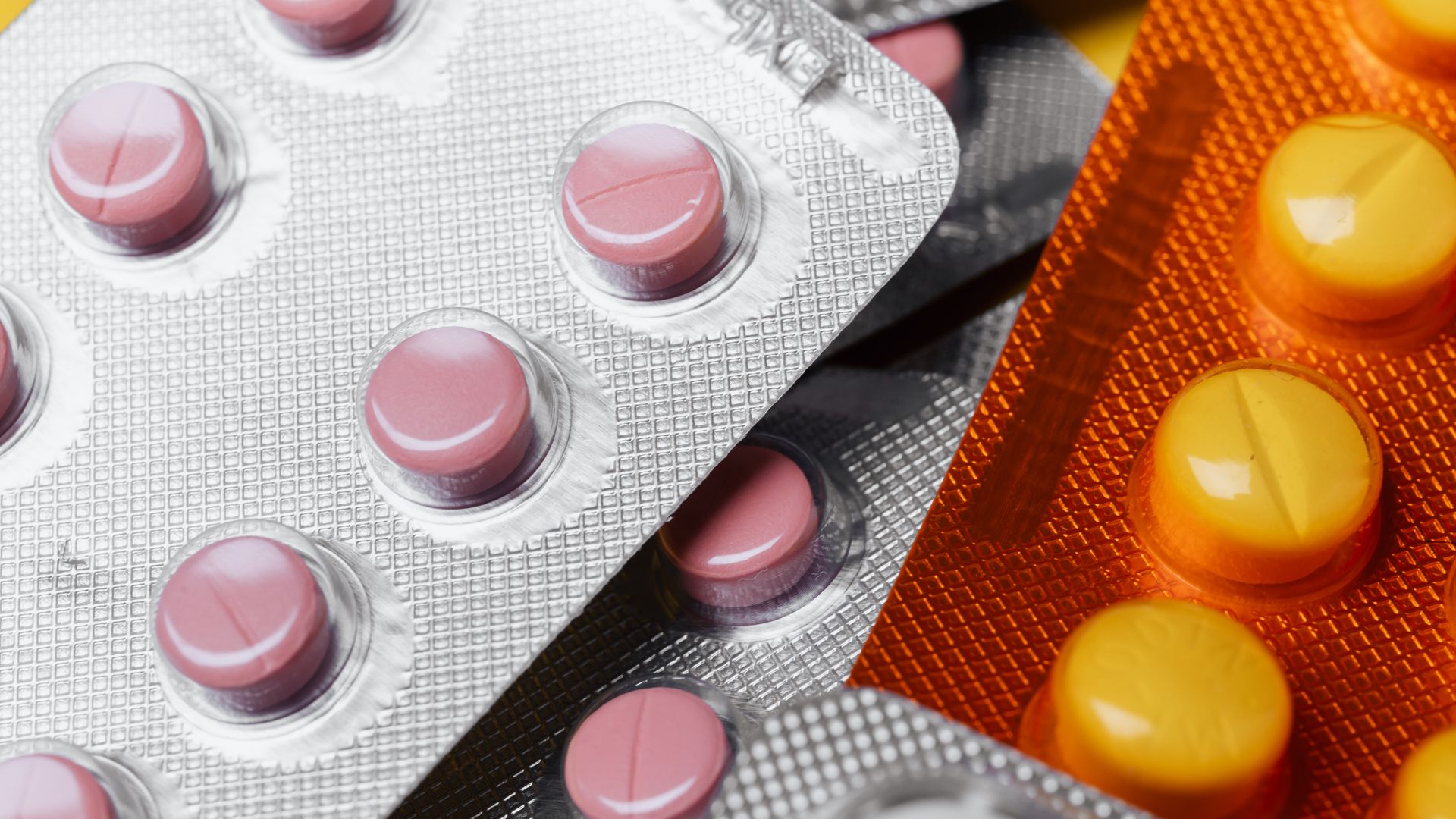 Modafinil FDA Approved Uses: Unlocking the Mystery From above closeup mix of various multicolored round pills of different sizes in plastic blister packs under bright light
