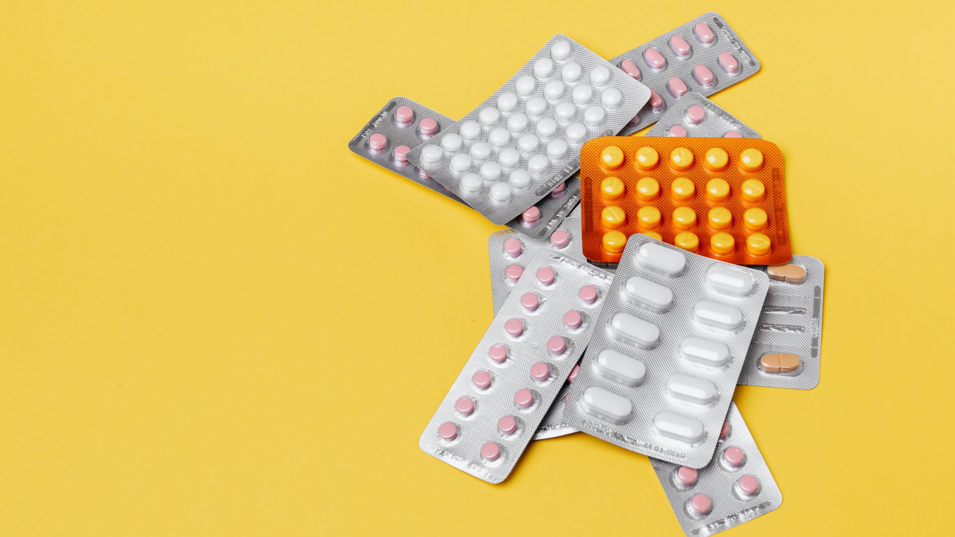 Modalert vs Artvigil: Unlocking the Best Smart Drug Choice From above of various medication blister packs of different color and shape on yellow background
