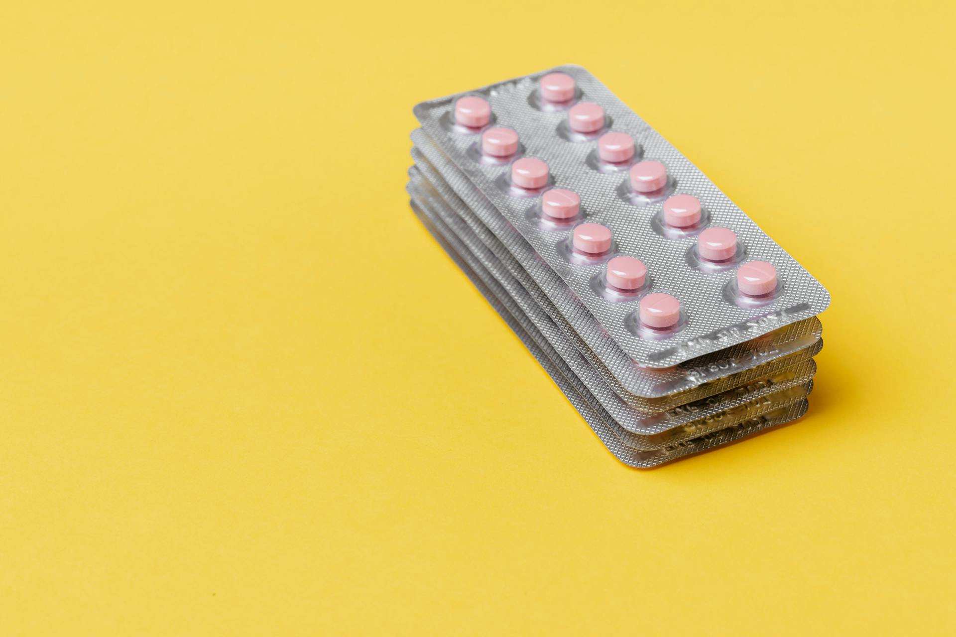 Stack of Pink Capsules on Blister Packs
