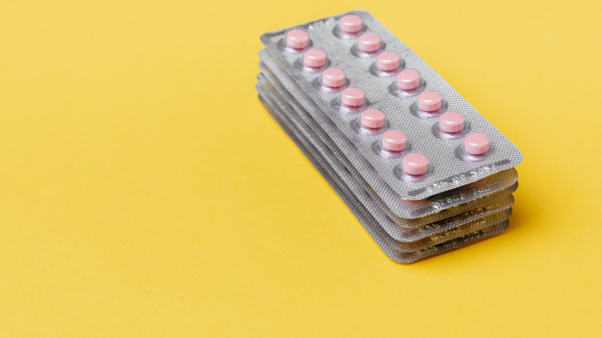 Modafinil Drug Class: Unlocking the Mystery From above set of small round pink pills packed in blisters on top of each other on yellow surface