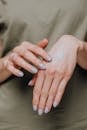 Crop woman applying cream on hands